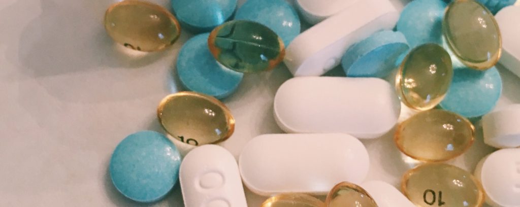 white, yellow, and blue pills