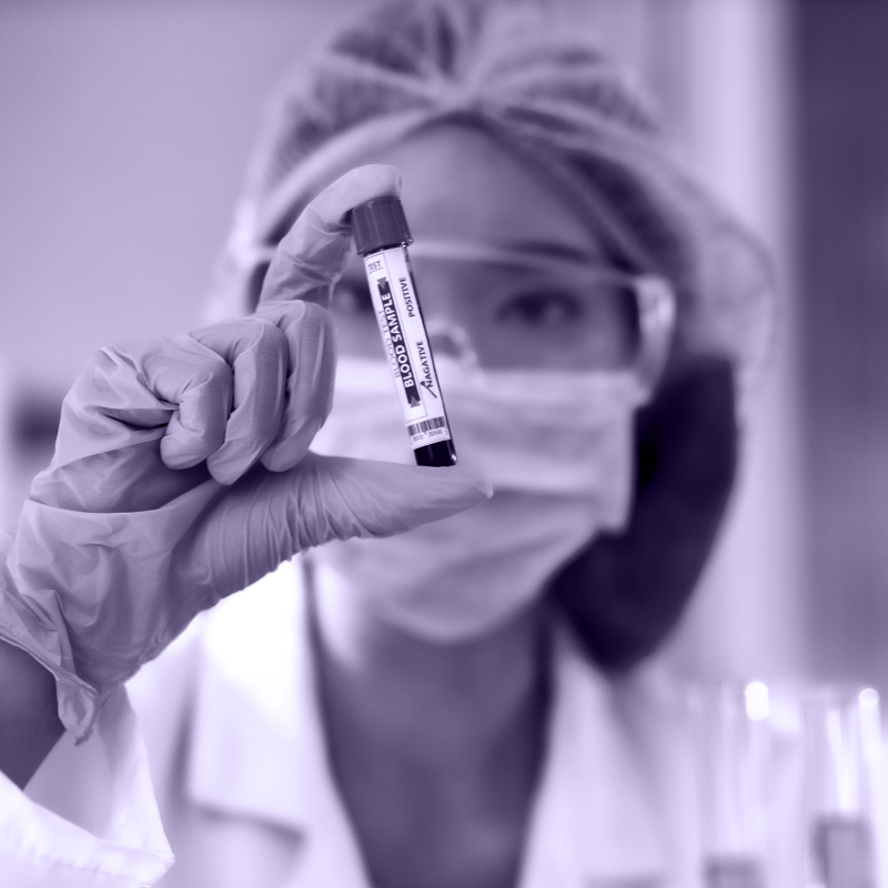 Technician with vial of blood